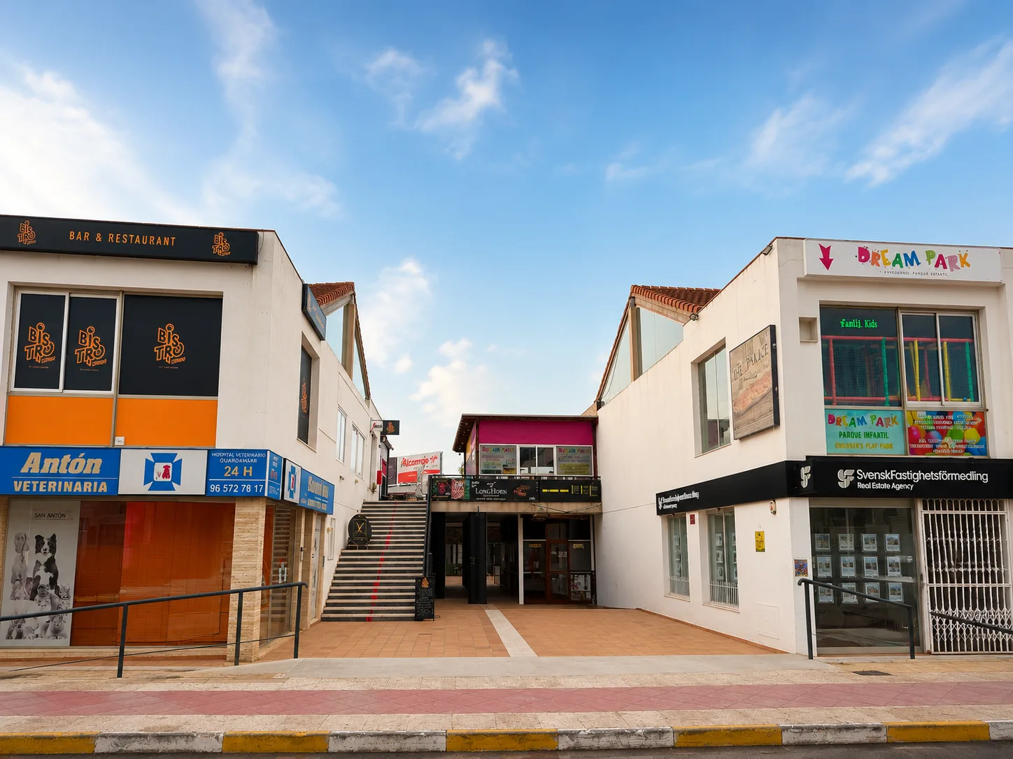 Central pedestrian plaza and main entrance of Flamenca Beach Shopping Centre in daylight, Orihuela Costa.
